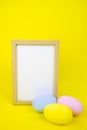 Easter layout. Frame for copy space isolate, on a yellow background and eggs. Royalty Free Stock Photo