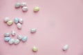 Easter little eggs painted with silver sprinkled on a pink background, preparation for the holiday