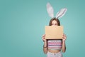 Girl wearing bunny ears holding a blank letter envelope Royalty Free Stock Photo