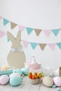 Easter! Many colorful Easter eggs with bunnies and baskets! Easter decoration of the room, children`s room for games. Basket with Royalty Free Stock Photo