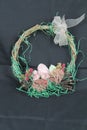 Easter deco in close-up. Wreath wicker with arrangement.