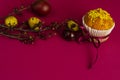 Easter muffin decorated with ribbon and sprinkles, colored eggs and a branch of apricot tree Royalty Free Stock Photo