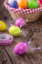 Easter. Multicolored easter eggs in a basket on a wooden table