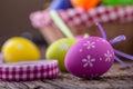 Easter. Multicolored easter eggs in a basket on a wooden table