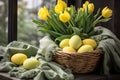 Easter nest and yellow tulips in vaser spring table setting decoration with eggs Royalty Free Stock Photo