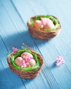 Easter nests with eggs and flowers decoration on blue background Royalty Free Stock Photo