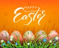 Easter orange composition, patterned eggs are drawn in the grass with flowers