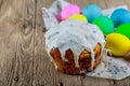 Easter orthodox sweet bread, kulich and colorful quail eggs with white tulips. Holidays breakfast concept