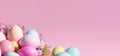 Easter, painted multicolored eggs in a basket, a wicker basket on a pink background, a birds nest, a place for