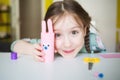 easter paper craft for kids. child girl making banny in kindergarten