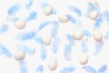 Easter pattern. light blue feathers and eggs on a white background. flat lay, top view Royalty Free Stock Photo