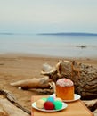 Easter picnic: Easter cake and colored eggs on white plates on a blurred background of the sandy banks of the Volga River