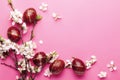Easter pink background with Easter eggs and spring flowers. Top view with copy space Royalty Free Stock Photo