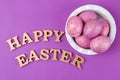 Easter. Pink Easter eggs in a bowl on a trendy lilac background. Happy easter. holidays. top view Royalty Free Stock Photo