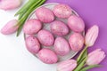 Easter. pink Easter eggs and flowers tulips on a trendy lilac and ball background. Happy easter. holidays. top view Royalty Free Stock Photo