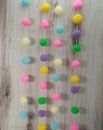 Easter pom poms on a string, pastel colors, curtain tiebacks, room dividers, Royalty Free Stock Photo