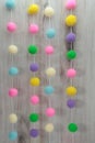 Easter pom poms on a string, pastel colors, curtain tiebacks, room dividers, Royalty Free Stock Photo
