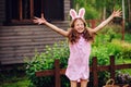 Easter portrait of happy child girl in funny bunny ears playing egg hunt outdoor Royalty Free Stock Photo