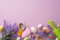 Top view photo of kitchen utensils bunch of lavender flowers colorful easter eggs in paper baking molds and sprinkles Royalty Free Stock Photo