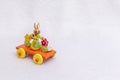 Easter rabbit bunny on train with an egg, a bucket and spring flowers - a wooden transport toy, a bright orange, yellow