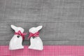 Easter rabbits decoration in interior on a wooden background in