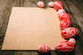 Easter red eggs with folk white pattern lay around sheet of paper on vintage wood table Royalty Free Stock Photo