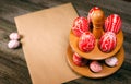 Easter red eggs with folk white pattern lay around stand for eggs which stand on rustic wood background. Top view. Ukrainian tradi