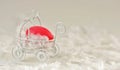 Easter red painted egg in a small souvenir baby stroller on a white background with white fluffy feathers. Royalty Free Stock Photo