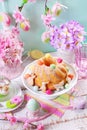 Easter ring cake with candy eggs and cookies on spring table