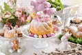 Easter ring cake with egg shaped candies and spring flower decoration on festive table Royalty Free Stock Photo