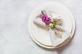 Easter romantic dinner. Elegance table setting with lilac flowers on light table. Top view.