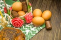 Easter russian still life. Eggs in a flower basket, sweets, rolls, prepared for rest on a wooden background Royalty Free Stock Photo