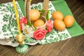 Easter russian still life. Eggs in a flower basket, sweets, rolls, prepared for rest on a wooden background Royalty Free Stock Photo