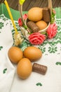 Easter russian still life. Eggs in a flower basket, sweets, rolls, prepared for rest on a wooden background Royalty Free Stock Photo