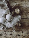Easter rustic flat lay. Natural eggs, feathers, willow branches, bird nest on aged wooden table Royalty Free Stock Photo