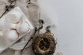 Easter rustic flat lay. Natural eggs, feathers, willow branches, nest on aged white table. Stylish rural Easter still life in