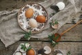 Easter rustic still life. Natural easter eggs, blooming spring flowers, burlap and spoon  flat lay on rural wooden table. Happy Royalty Free Stock Photo