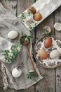 Easter rustic still life. Natural easter eggs, blooming spring flowers, burlap and spoon  flat lay on rural wooden table. Simple Royalty Free Stock Photo