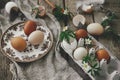 Easter rustic still life. Natural easter eggs, blooming spring flowers, burlap and spoon on rural wooden table. Happy Easter! Royalty Free Stock Photo