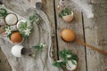 Easter rustic still life. Natural easter eggs, blooming spring flowers, feathers, burlap and spoon on rural wooden table. Happy Royalty Free Stock Photo