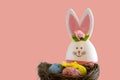 Colored eggs, easter bunny,, pink background