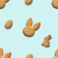 Easter seamless pattern of cookies shaped of bunny and eggs on blue background. Royalty Free Stock Photo
