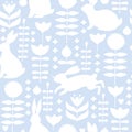 Easter seamless pattern with .silhouette of cute various bunnies, flowers and leaves on blue background.