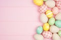 Easter side border with rustic cloth and pastel colored eggs over a pink wood background