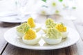 Easter snack^ Eggs stuffed with cheese and avocado mousse Royalty Free Stock Photo