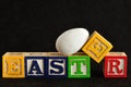 Easter spelled with alphabet blocks and a easter egg Royalty Free Stock Photo