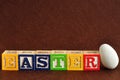 Easter spelled with alphabet blocks and a easter egg Royalty Free Stock Photo