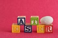 Easter spelled with alphabet blocks and a easter egg Royalty Free Stock Photo