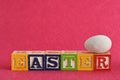 Easter spelled with colorful alphabet blocks and eggs Royalty Free Stock Photo