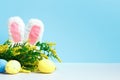 Easter spring composition. Rabbit ears flowering branch and eggs on the table Royalty Free Stock Photo